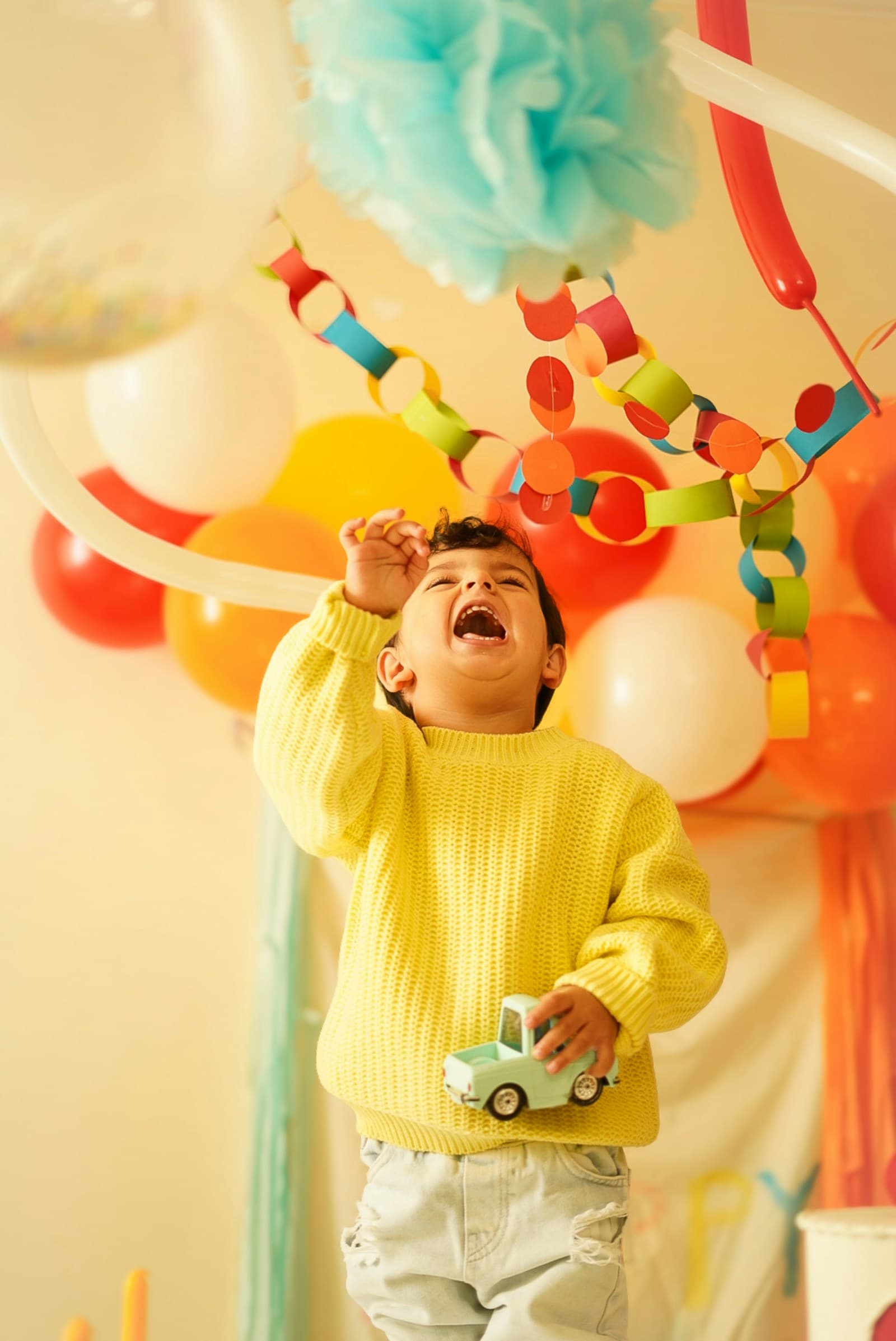 Kid reaching for balloons
